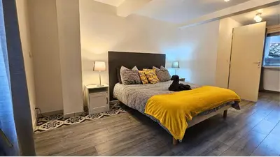 a bedroom with a bed with a cat sitting on it at La Pause Laurag-aise l'embleur Oc Keys 27 in Castelnaudary