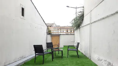 a group of chairs and a table in an alley at Castelnaudary - Appartement JARDIN in Castelnaudary