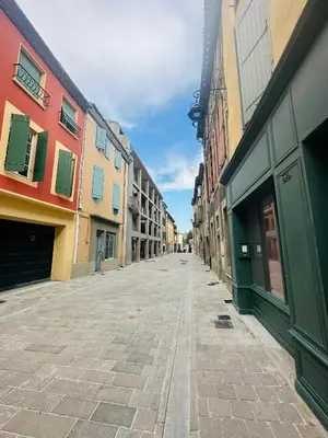 an empty street in a city with colorful buildings at Rooftop Face à la Cité 'RFC' in Carcassonne