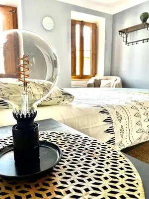 a room with a bed and a table with a fan at Rooftop Face à la Cité 'RFC' in Carcassonne