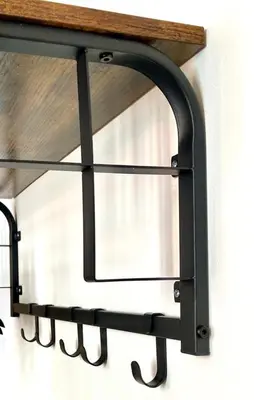 a black metal shelf hanging on a wall at Rooftop Face à la Cité 'RFC' in Carcassonne
