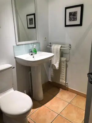 a bathroom with a white sink and a toilet at The Courtyard in Castres