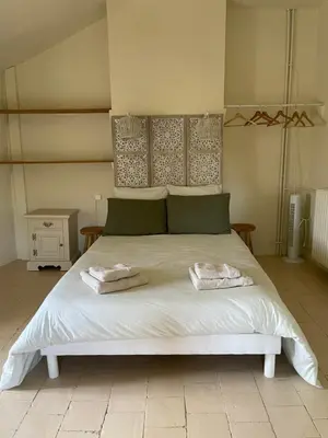 a bedroom with a bed and a dresser and a chair at Monte Vinea in Montouliers