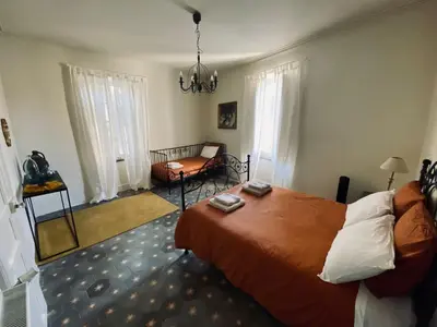 a bedroom with a bed and a chandelier at Monte Vinea in Montouliers