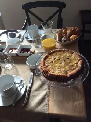 a table topped with a pie and a plate of food at La villa du chai in Lézignan-Corbières