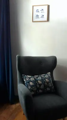 a blue chair with a pillow in a room at La villa du chai in Lézignan-Corbières