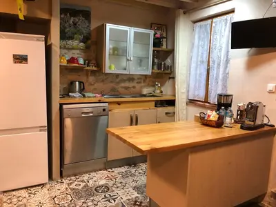 a kitchen with a refrigerator and a wooden counter top at Carcahouse in Carcassonne