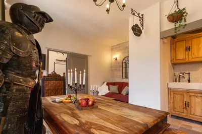 a room with a table with fruits and candles at Le Secret de la Taverne - Netflix/Wifi - Chasse Aux Trésor à l'intérieur in Carcassonne