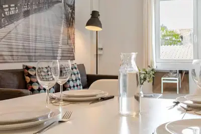 a dining room table with glasses and plates on it at Appartement 
