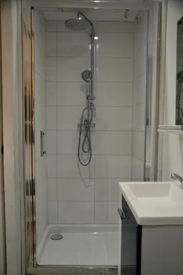 a bathroom with a shower and a sink at Appartement 