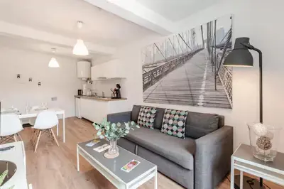 a living room with a couch and a table at Appartement 