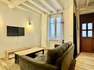 a living room with a couch and a table at Maison Jebari - Carcassonne centre in Carcassonne