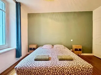 a bedroom with a bed with two pillows on it at Maison Jebari - Carcassonne centre in Carcassonne