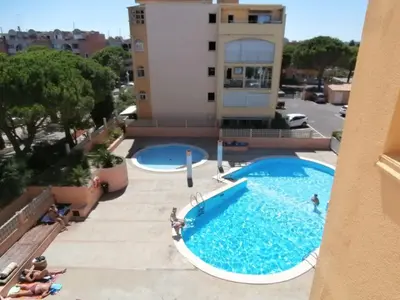 a view of a swimming pool from a building at APPARTEMENT SUR LE PORT DE Gruissan in Gruissan