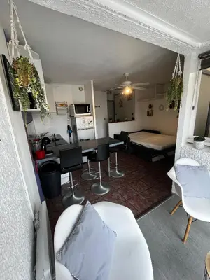 a room with a table and chairs and a dining room at APPARTEMENT SUR LE PORT DE Gruissan in Gruissan