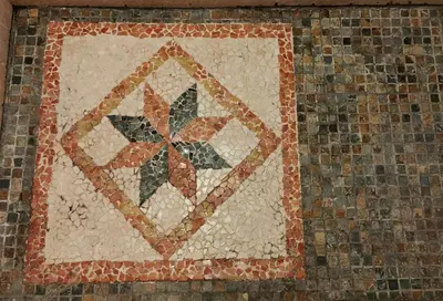 a mosaic of a flower on the side of a wall at Residence La Borde in Plavilla