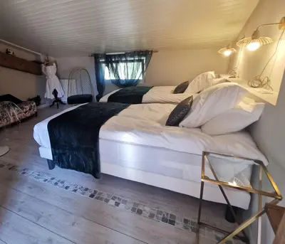 a bedroom with two large beds in a room at Residence La Borde in Plavilla