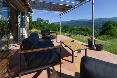 a patio with a table and chairs and a view at The Restoration Place Pyrenees in Roquefixade