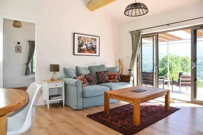 a living room with a couch and a table at The Restoration Place Pyrenees in Roquefixade