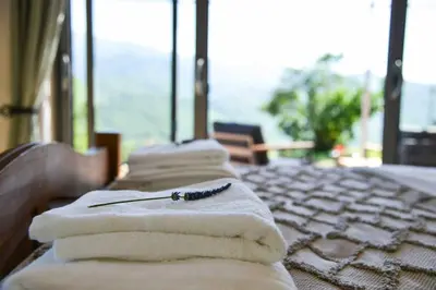 a row of towels sitting on a table with a toothbrush at The Restoration Place Pyrenees in Roquefixade