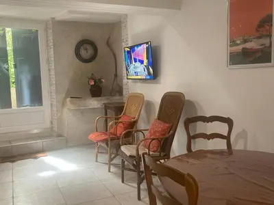 a dining room with a table and chairs at Maison DELMAS, l'Oustal du Recantu in Sainte-Eulalie