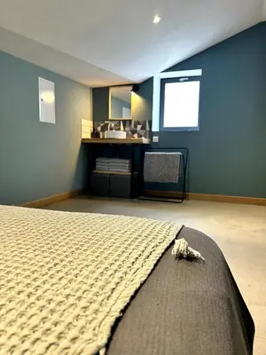 a bedroom with a bed in a room with a window at Côté Nuit in Capestang