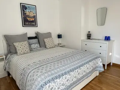 a bedroom with a bed and a dresser at Les Deux Chevaux Chambres d’Hôtes in Rouvenac