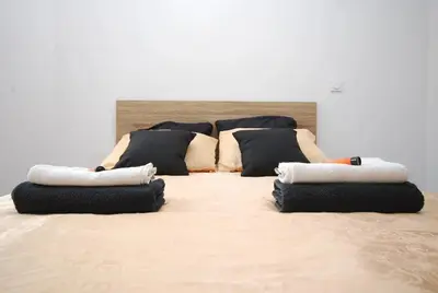 a group of pillows sitting on top of a bed at Cosy Centre Ville Narbonne in Narbonne