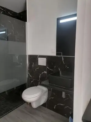 a bathroom with a white toilet and a sink at Cosy Centre Ville Narbonne in Narbonne