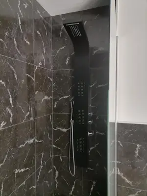 a shower with a black shower head in a bathroom at Cosy Centre Ville Narbonne in Narbonne