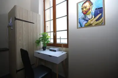a room with a desk and a painting on the wall at Baignoire Cosy Centre Narbonne in Narbonne