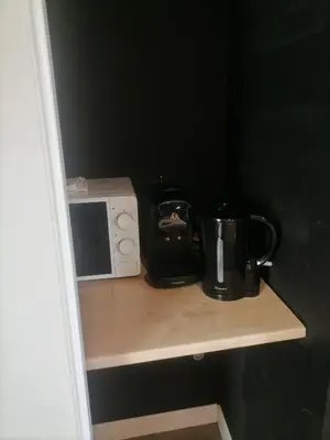 a counter with a microwave and a coffee maker on it at Studio Baignoire centre ville in Narbonne