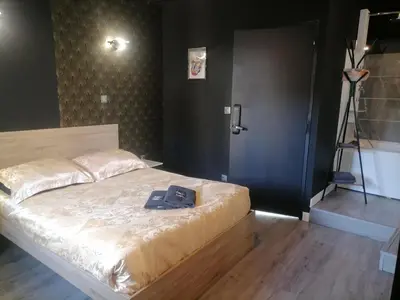 a bedroom with a bed with a book on it at Studio Baignoire centre ville in Narbonne