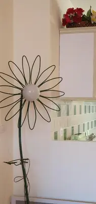 a statue of a flower on a wall at La maison de mon enfance ! Au cœur du Minervois ! in Félines-Minervois