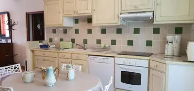 a kitchen with a table with a white table cloth at La maison de mon enfance ! Au cœur du Minervois ! in Félines-Minervois