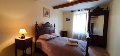 a bedroom with a bed and a lamp and a mirror at La maison de mon enfance ! Au cœur du Minervois ! in Félines-Minervois