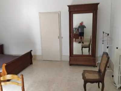 a person is taking a picture in a mirror at Maison Alba La Source in Mazamet
