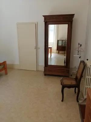 a living room with a mirror and a chair at Maison Alba La Source in Mazamet