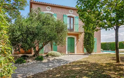 a house with a green door and trees at Beautiful Home In Carcassonne in Carcassonne
