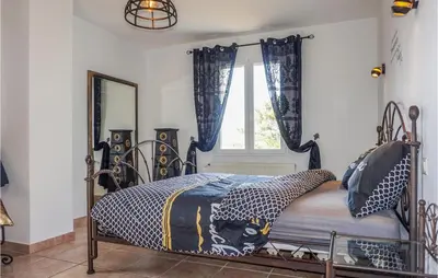 a bedroom with a metal bed with a window at Beautiful Home In Carcassonne in Carcassonne