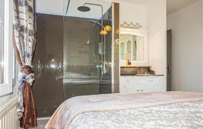 a bathroom with a shower and a bed in a room at Beautiful Home In Carcassonne in Carcassonne
