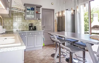 a kitchen with a table and some chairs in it at Beautiful Home In Carcassonne in Carcassonne