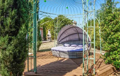 a bed in a gazebo in a garden at Beautiful Home In Carcassonne in Carcassonne