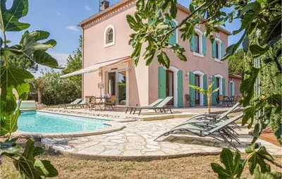 a villa with a swimming pool in front of a house at Beautiful Home In Carcassonne in Carcassonne