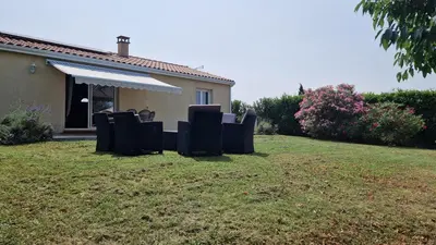 a yard with chairs in front of a house at Chambre d'hôte Lempautoise in Lempaut