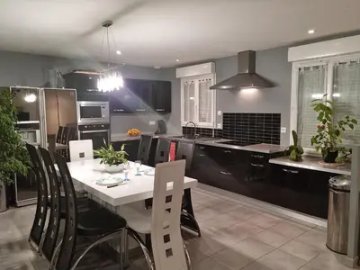 a kitchen with a white table and chairs in it at Chambre d'hôte Lempautoise in Lempaut