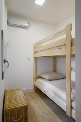 a bedroom with a bunk bed with a wooden bunk ladder at Magnifique appartement plein centre, calme, Netflix in Mirepoix