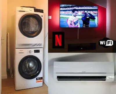 a tv and a washing machine in a room at T2 chaleureux au centre de castelnaudary in Castelnaudary