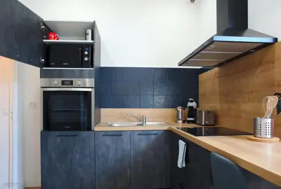 a kitchen with a sink and a stove top oven at T2 chaleureux au centre de castelnaudary in Castelnaudary