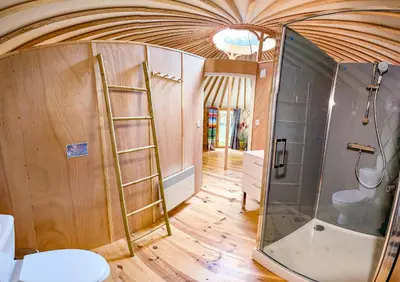 a bathroom with a shower and a ladder in a room at Au bois de Mars in Les Martys